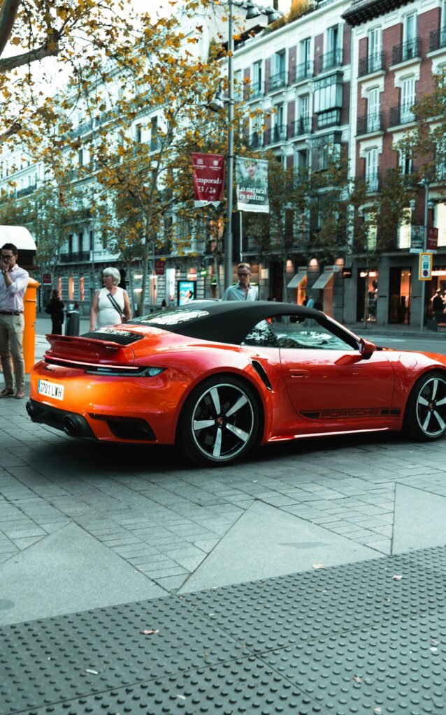 a red sports car parked on the side of the road